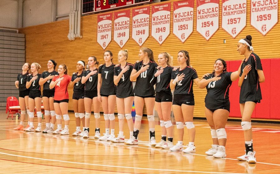 The 21'-22' EvCC Volleyball Team together, pledging towards the national anthem, during the Sept 24th game against the Shoreline Dolphins.