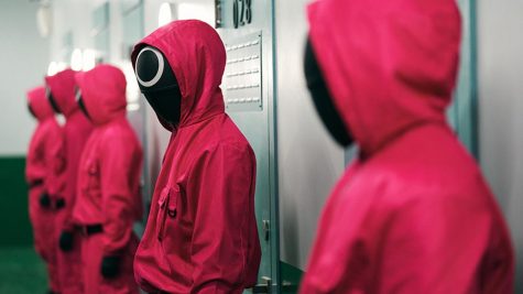 Squid Games guards, shown here in loud pink jumpsuits, are treated just as disposably as its players.