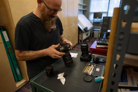 Michael Rhodes tests a camera that was recently returned to the Equipment Room by a student