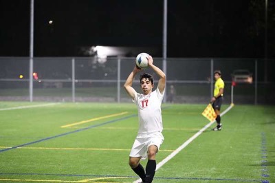 Juan Castillo completes a throw-in for Evccs Soccer team. Online courses help him balance athletics with academics.