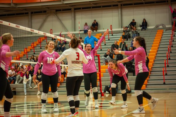 The team celebrates together after scoring a point in the second set of the match vs Whatcom. The Trojans won the match in four sets to improve to 4-4 in division.