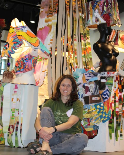 Jamie Curtismith with the colorful centerpiece of her mixed media showcase. 