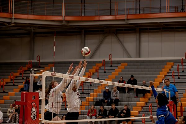 Morgan Armitage (left) and Annika Mason (right) go up to block a spike from Edmonds on October 18.