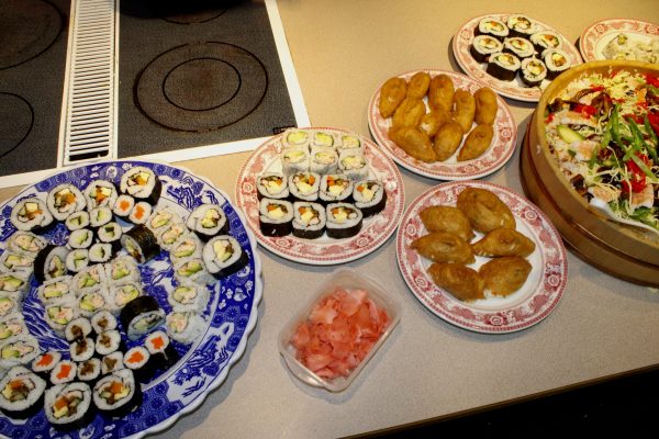 A spread of sushi and other dishes prepared by community members during the class.