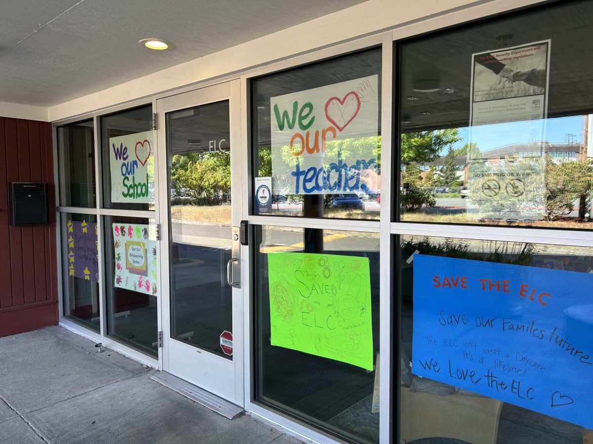 Posters made by parents of the ELC's students are taped to the windows of the building. 