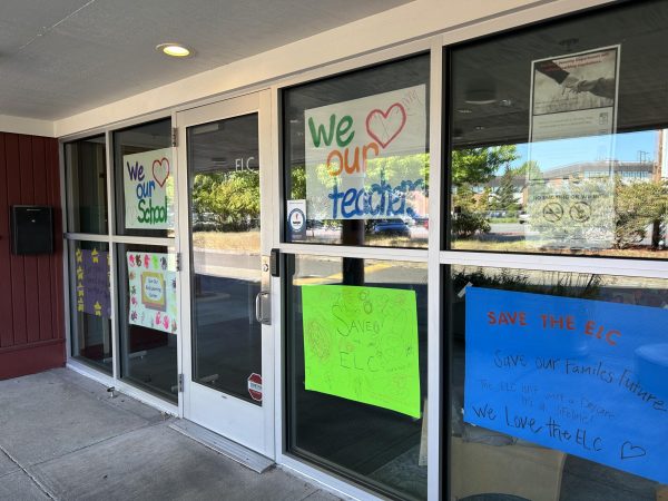 Posters made by parents of the ELC's students are taped to the windows of the building. 