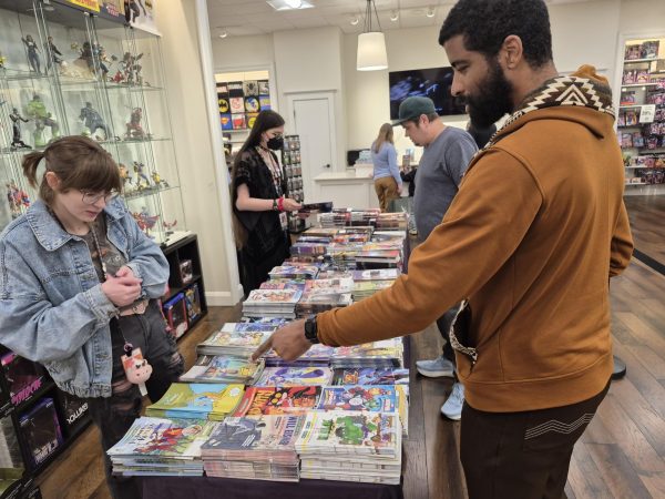 Free comics were laid out on a table where store employees helped customers obtain their free comics at Phantom Zone Comics. Customers were limited to five comics each and families were limited to eight.