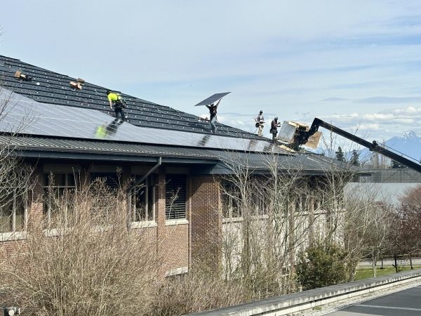 The team at Ellensburg Solar work in the morning to install an entire array of solar panels.