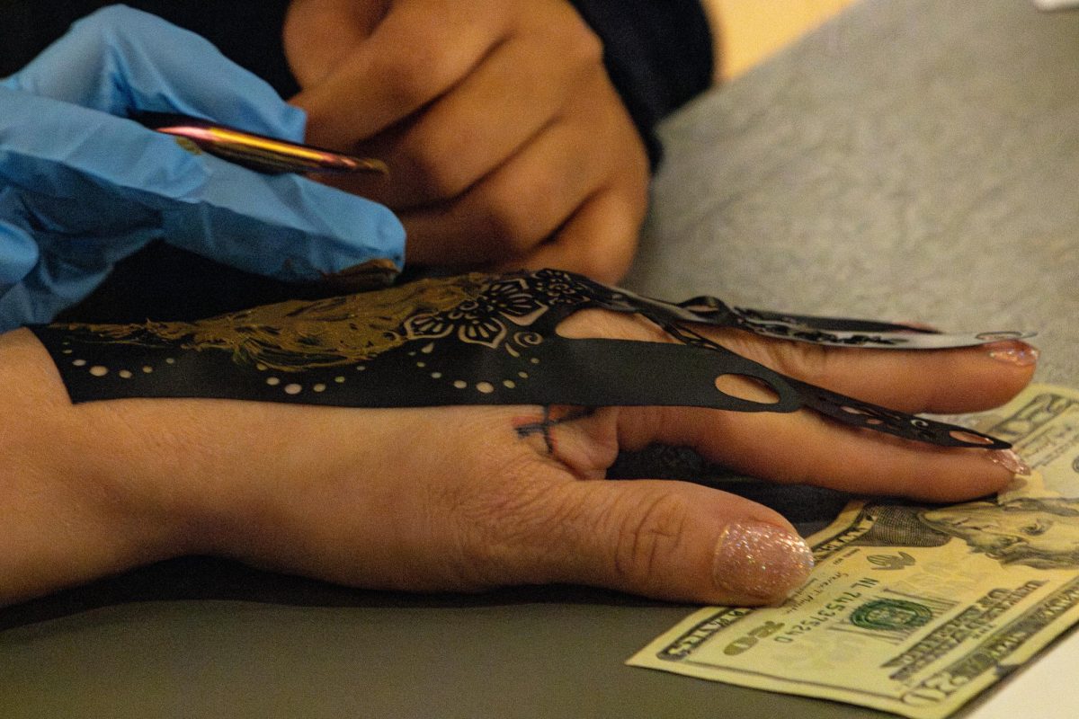 Most of the hand-sized henna stencil designs included floral patterns which stretched towards the fingertips.
